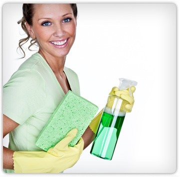 A smiling cleaner holding a sponge and spray bottle
